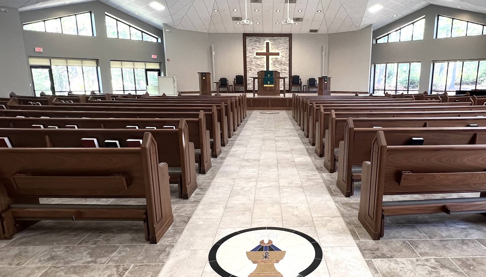 The sanctuary of Sandhills Presbyterian Church, looking down the center aisle toward the cross.